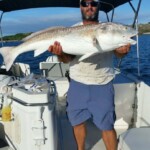 Huge redfish caught on a fishing trip with Cast Away Adventures, showcasing expert angling experiences in Florida's scenic waters.