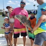 Black drum on fishing trip, family enjoying fishing adventure at Cast Away Adventures, engaging in fun outdoor fishing activity on beautiful Florida coastal waters, perfect for family fishing vacations.