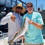 Nice redfish caught during a fishing trip with two men on a boat, part of Cast Away Adventures in Florida, emphasizing fishing, angling, outdoor adventure, and marine experience.