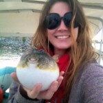 Caught with a pufferfish during a Cast Away Adventures fishing trip, enjoying marine life exploration on a tropical boat tour in Florida waters.